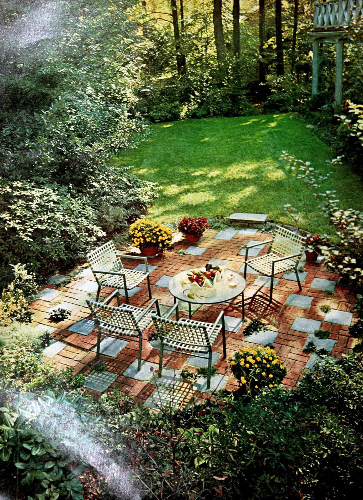 Inviting backyard with two-tone concrete decking on patio (1968)