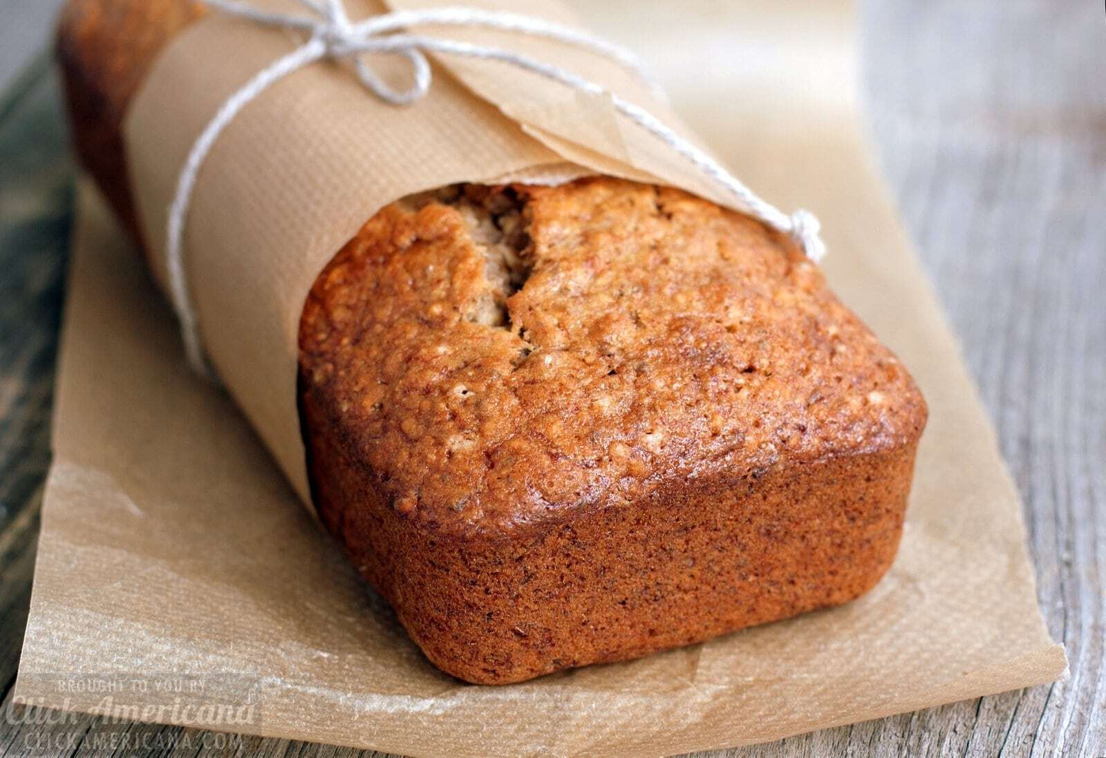 Banana bread in baking paper on table