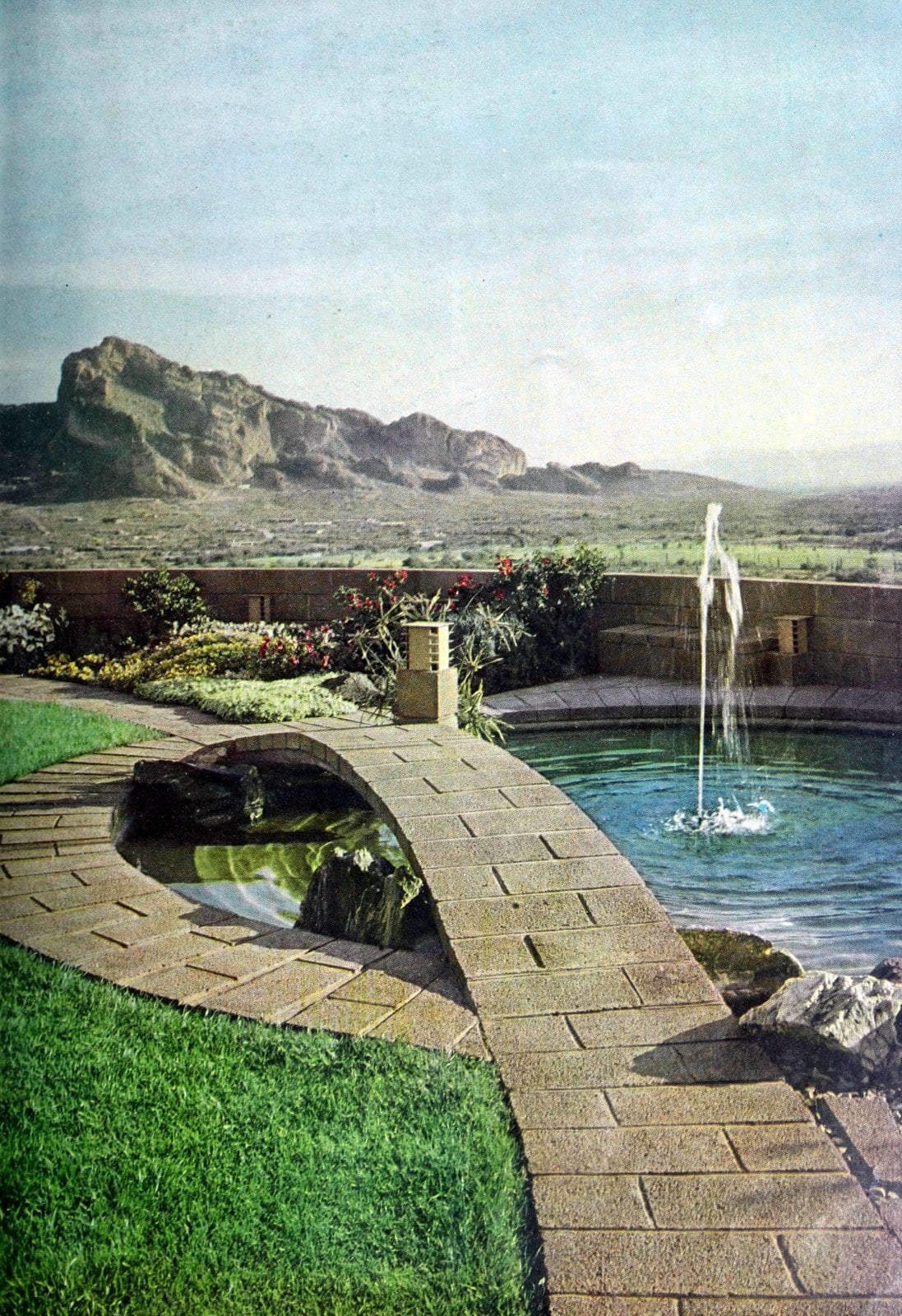 Desert backyard design with concrete pathway over fountain pool (1961)