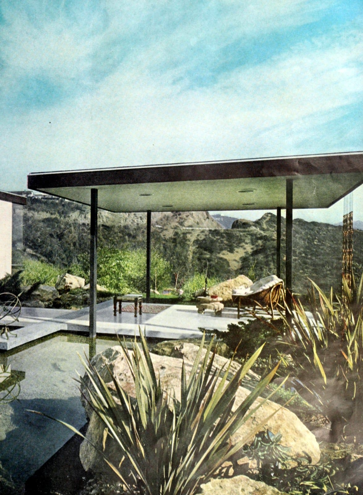 Minimal midcentury modern backyard covered patio area and pond (1960)