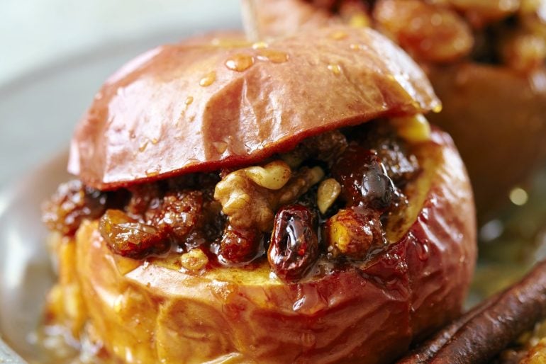 Old-fashioned baked apples with walnuts, sugar, cinnamon, and raisins